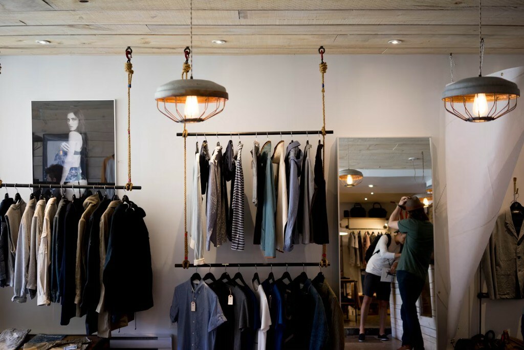 Luxury boutique showroom interior with herringbone flooring and directional display lighting in Delhi NCR by Arqvexa