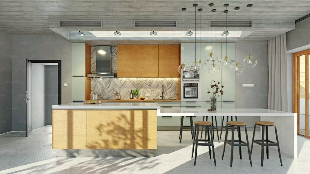 Open-plan kitchen with concrete finishes, marble island and globe pendant lights in Delhi NCR