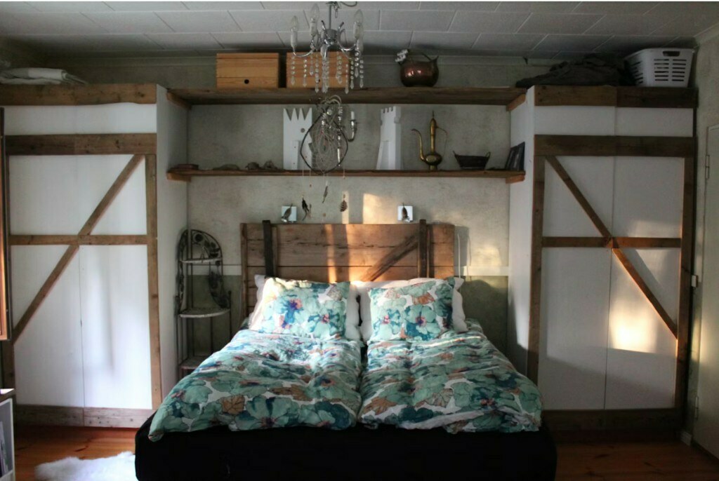 Bedroom with reclaimed wood barn-style wardrobe and custom shelving in Gurgaon residential interior